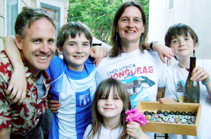 The Muller family, showcasing son George’s bottle cap collection. Alumni Mark & Amy married in 1996.